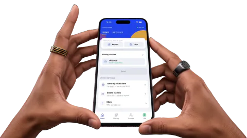 Hands holding devices running Likz Drop